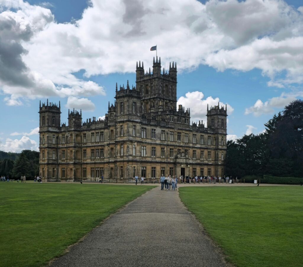 pexels-photo-17749561-17749561 Highclere Castle, iconic historic castle in England, with tourists enjoying the visit.